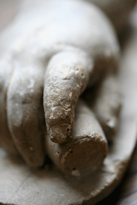 <stone carving of a child's hand>